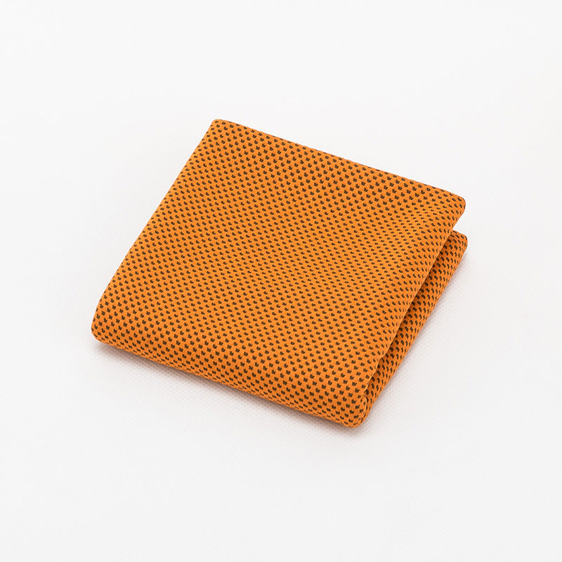 Orange Solfetti Cooling Towel folded to show its woven mesh texture